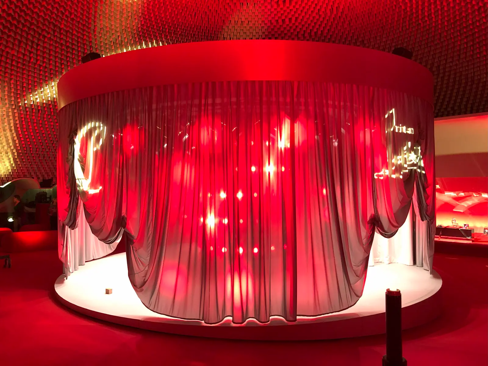 Circular red fabric installation lit from the inside