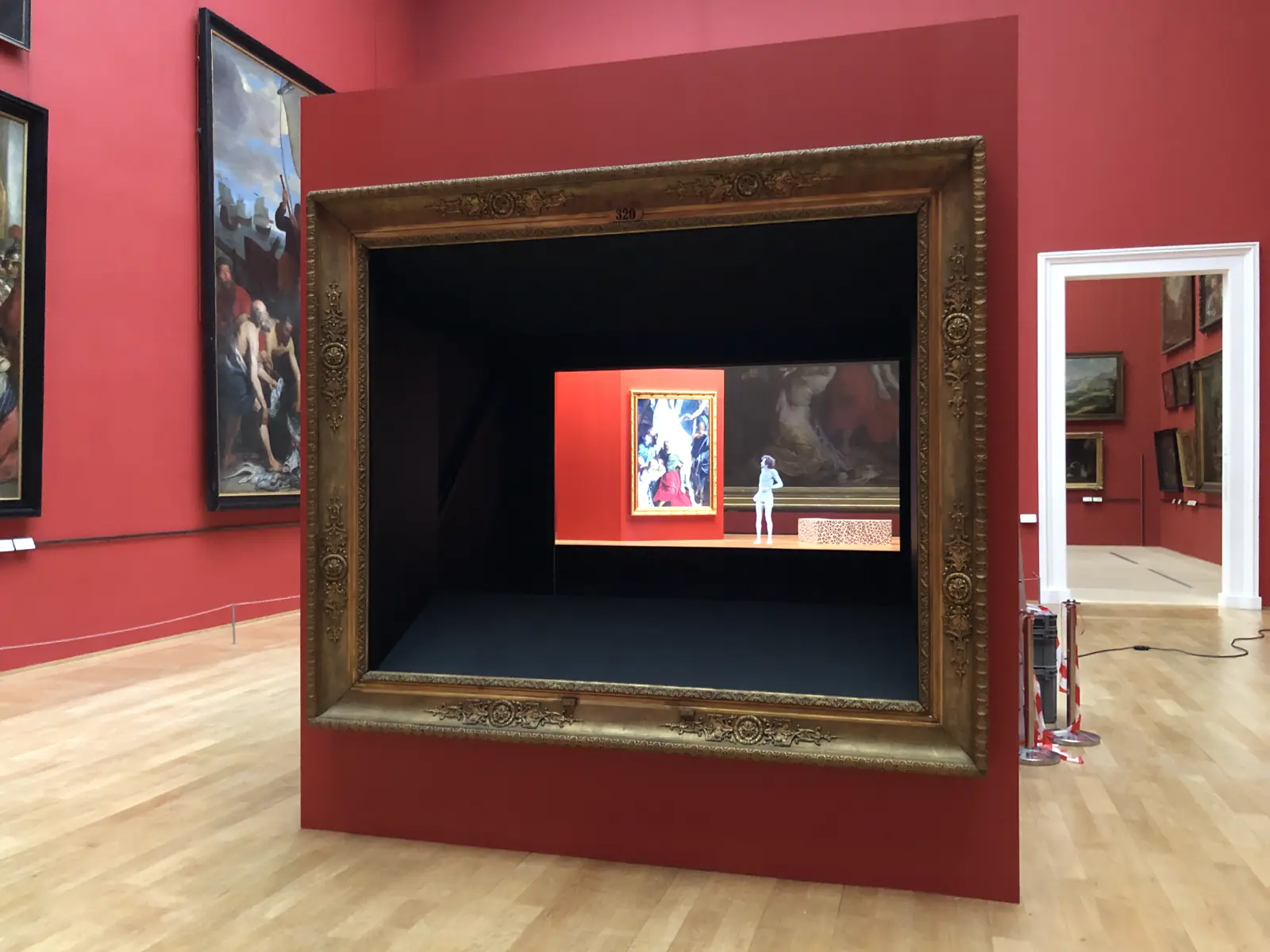 Museum scenography: a large gilded frame around a recessed display